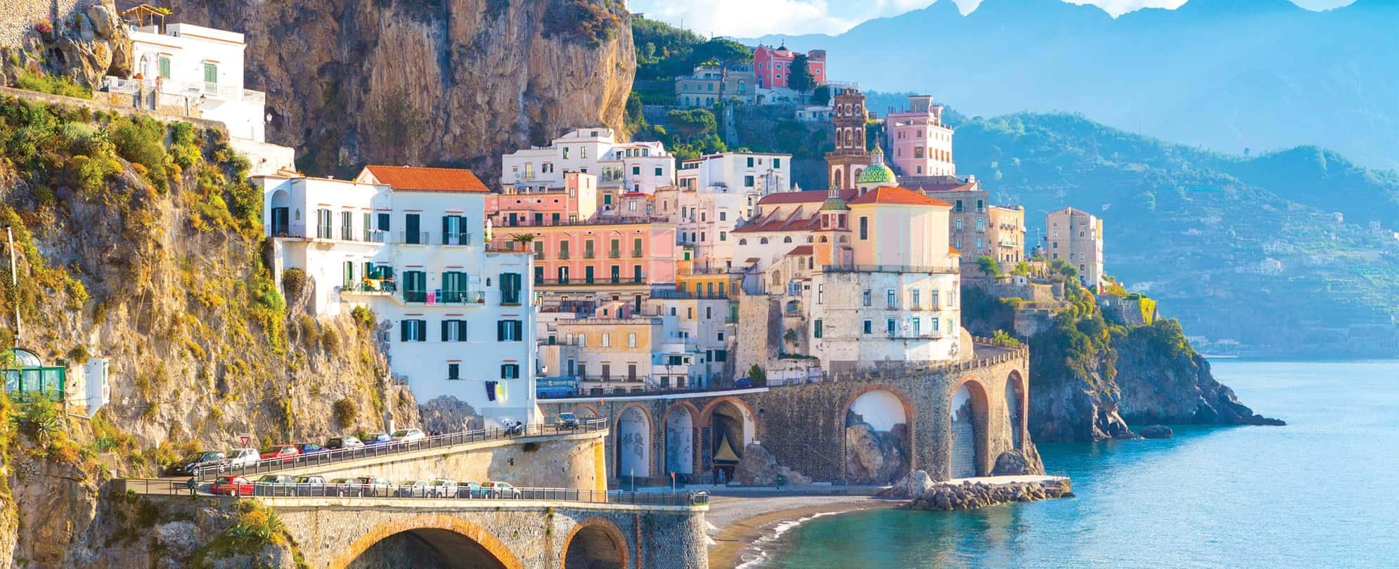 Italy's Amalfi Coast, with colorful buildings and roadway built into the waterfront mountainside.