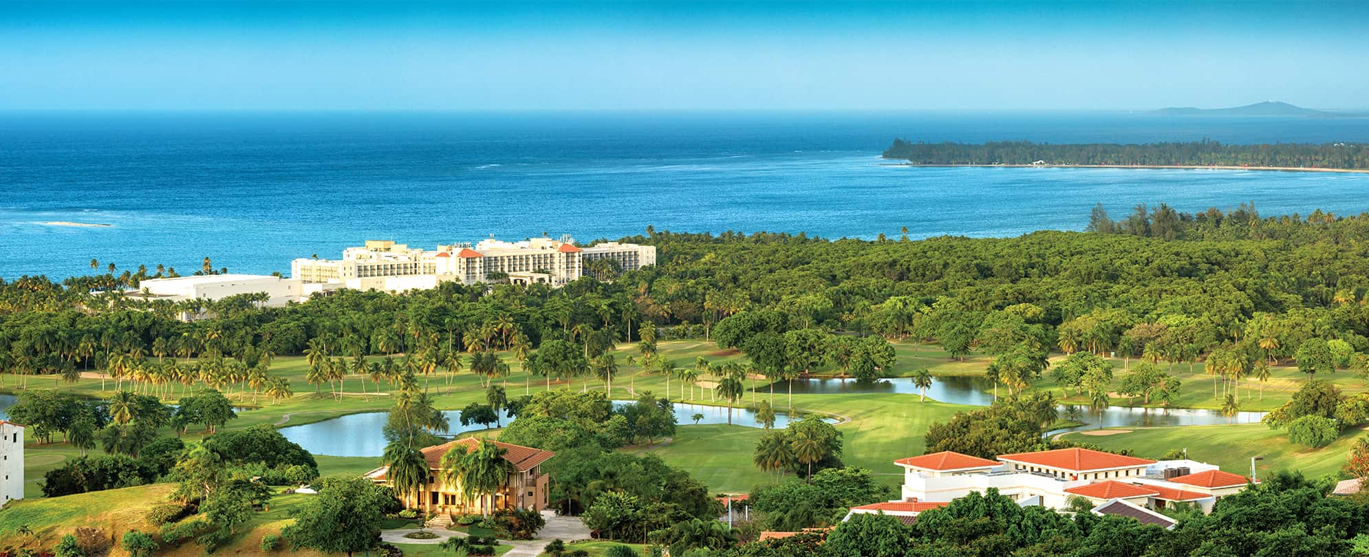 A birds-eye-view of the ocean, resort, and golf course at Margaritaville Vacation Club by Wyndham - Rio Mar in Puerto Rico.
