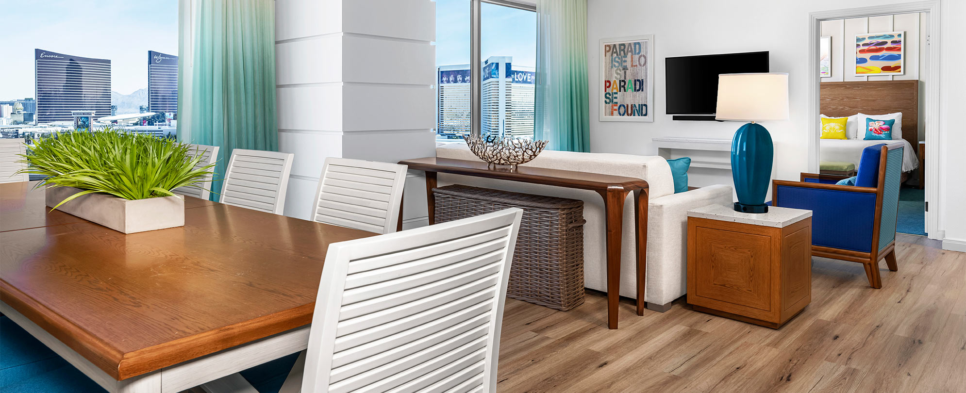 Chic living and dining room decorated with wood furniture at Margaritaville Vacation Club by Wyndham - Desert Blue in Las Vegas, NV.
